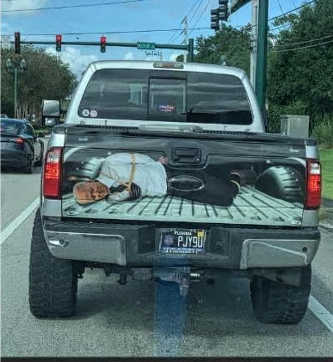 Template meme Joe Biden hogtied for execution in pickup truck